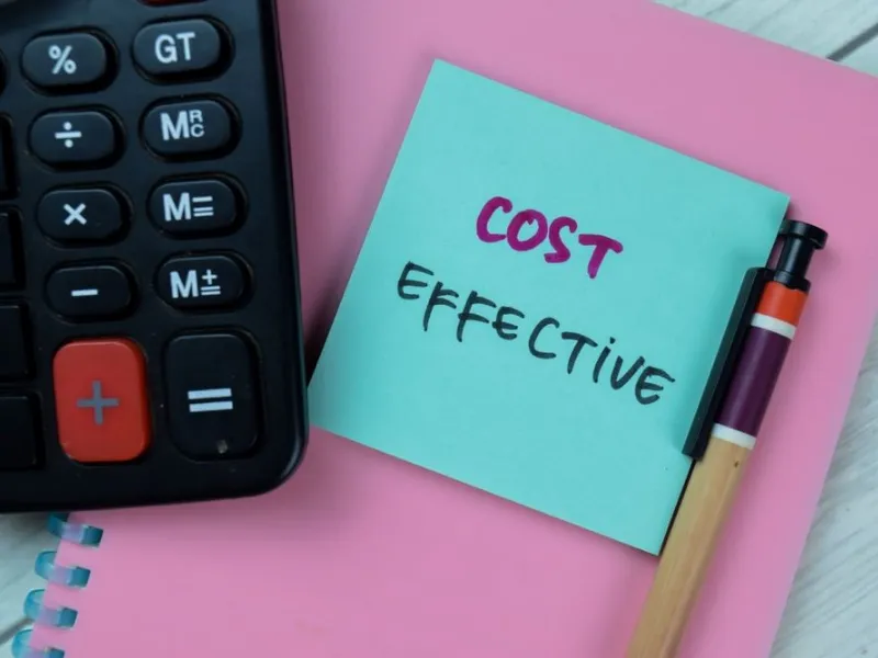 Rov's-Cost-Effectiveness calculation with pen and notebook
