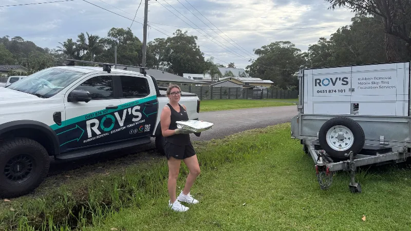 woman in black holding a tray